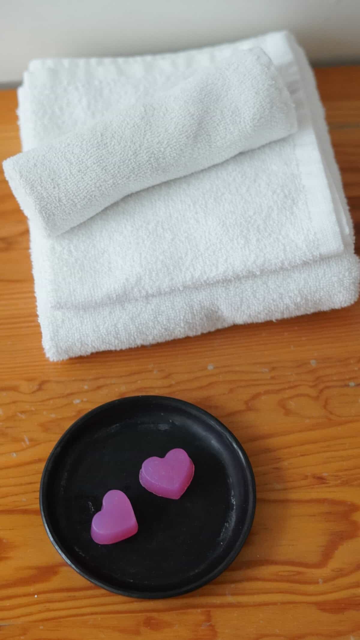 towels and soap in the shape of a heart